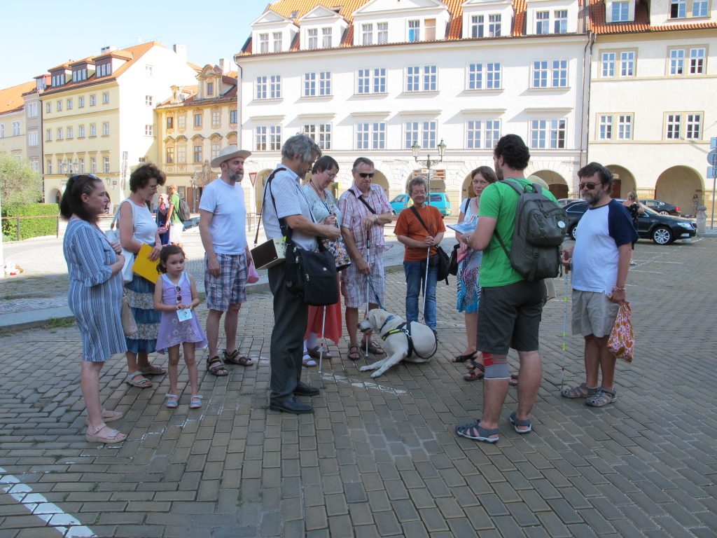 Účastníci vycházky pro zrakově handicapované v Praze se sešli na Loretánském náměstí.